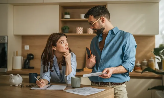A young couple discusses their mortgage repayments.