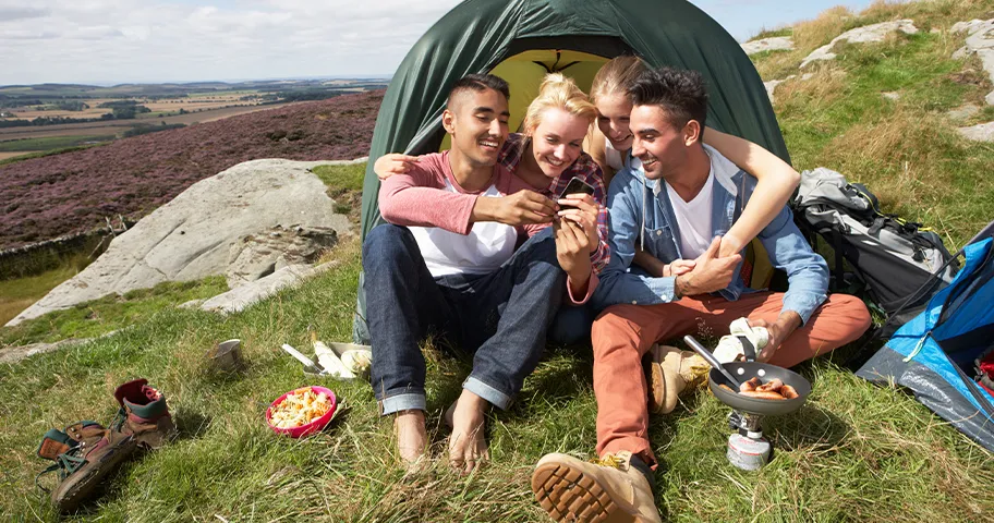 Group of young campers checking phone