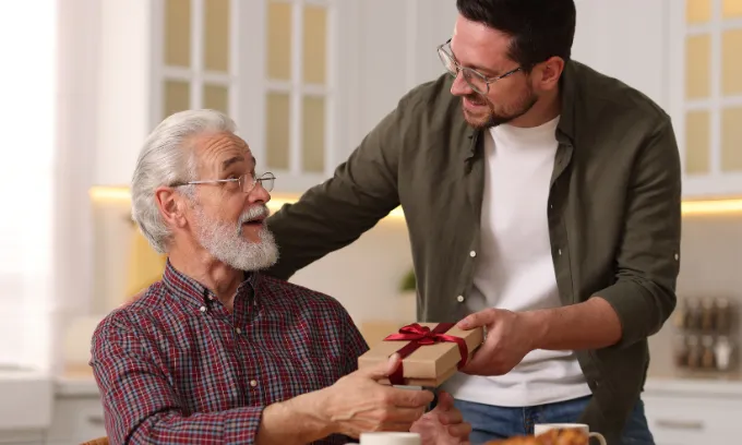 A son giving his dad a Father's Day gift.