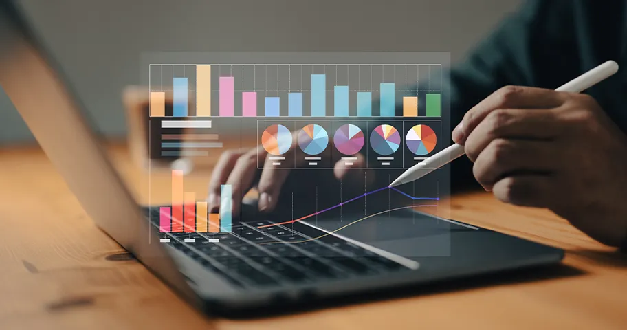 Laptop overset by graphic of bar and pie charts.