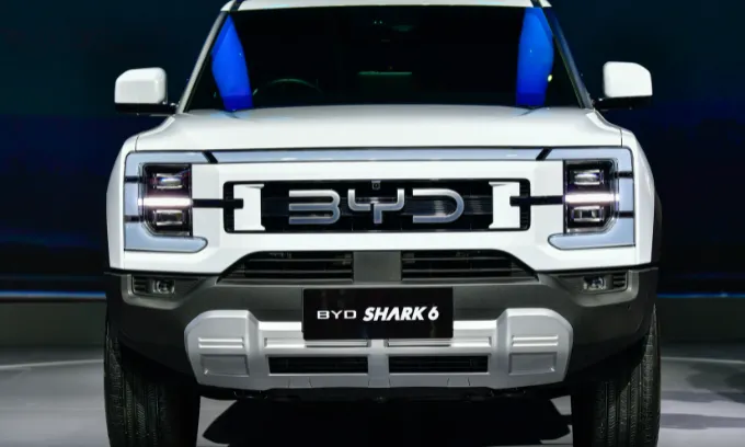 BYD Shark 6 in a neon lit showroom