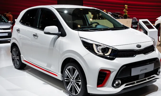 A white KIA Picanto on display in a showroom.