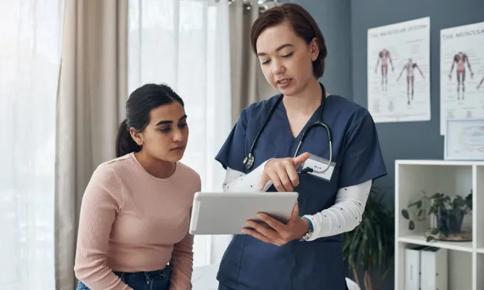 A doctor talks through the exclusions in a patient's health insurance policy