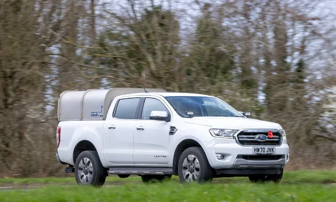 White Ford Ranger driving in the countryside