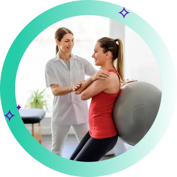 Exercise physiotherapist guiding a woman's exercise on an exercise ball