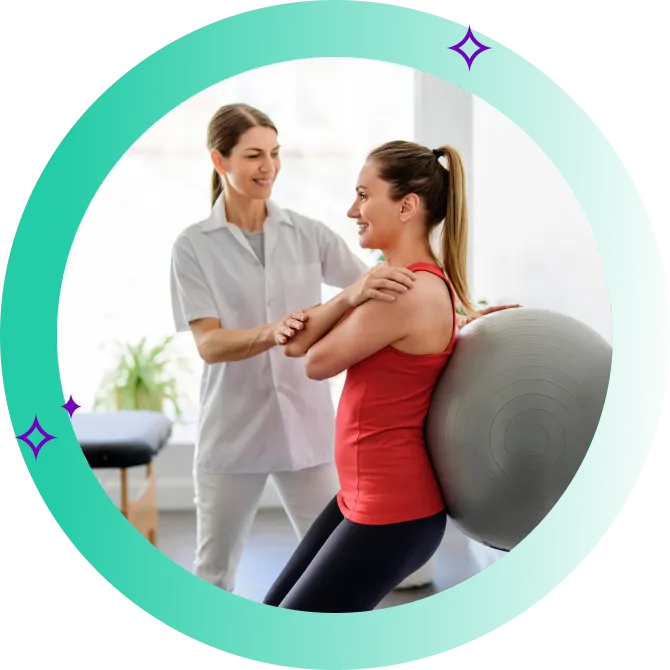 Exercise physiotherapist guiding a woman's exercise on an exercise ball