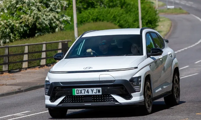 White hyundai Kona driving on the road