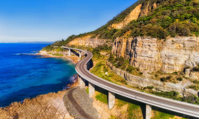 Sea cliff bridge section of the Grand Pacific next to a steep sandstone cliff 
