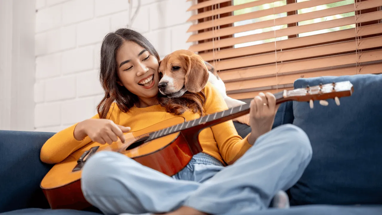 Pet insurance - woman and dog with guitar
