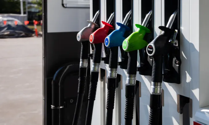 A line of different coloured petrol pumps