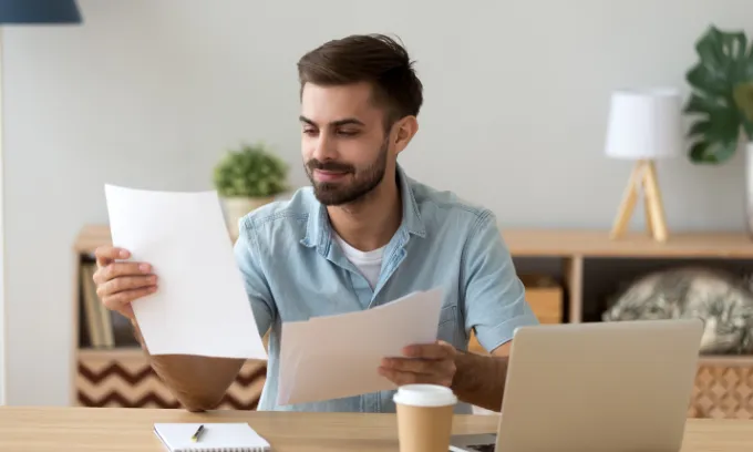 A man reviewing a contract of offer with a subject to finance clause