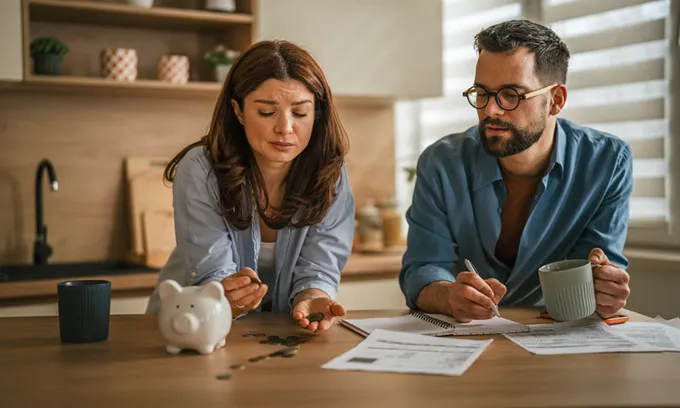 Concerned couple paying electricity bill